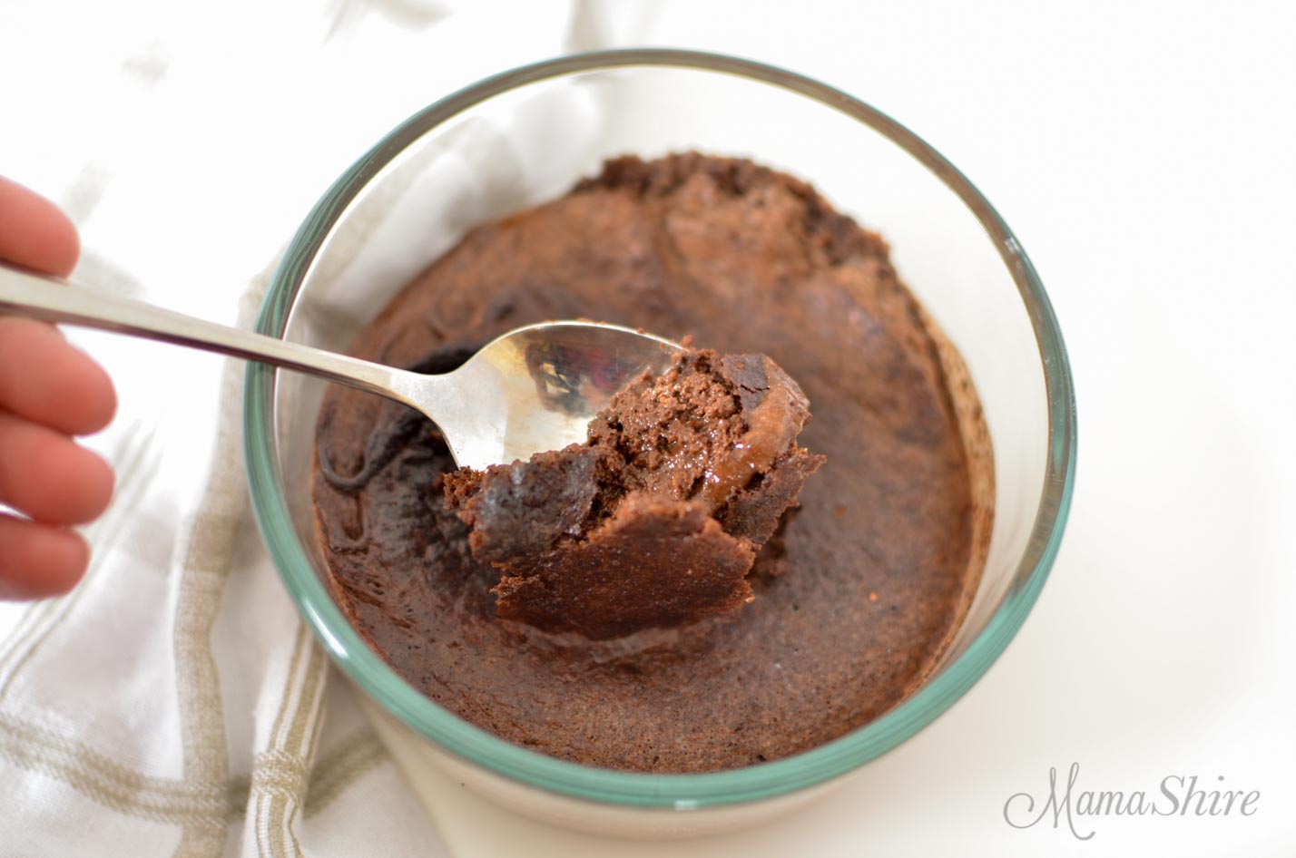 Chocolate Lava Cake with spoon lifting out the ooey-gooey goodness. 