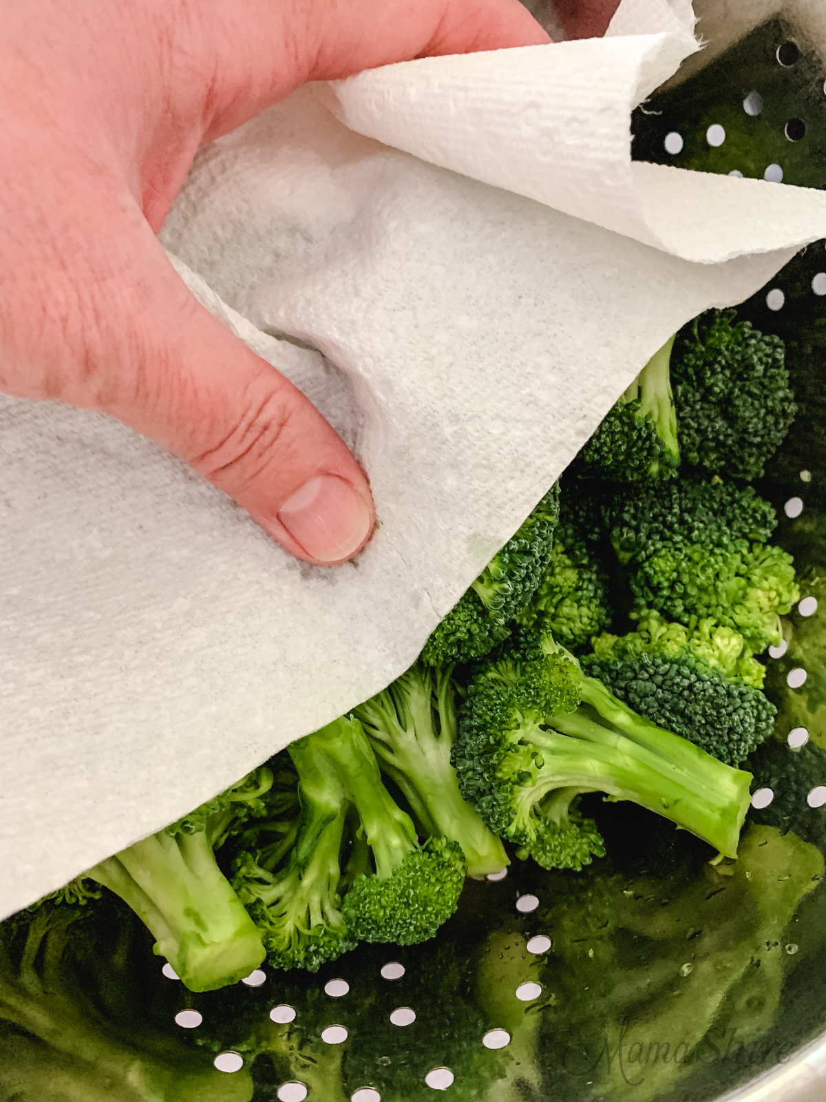 Drying broccoli before air frying.