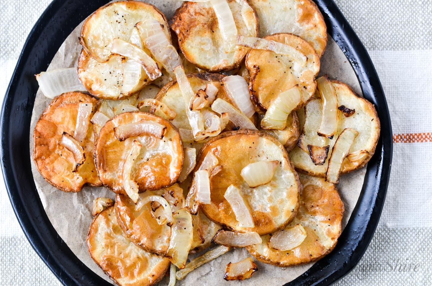 Crispy air fryer potato slices with onions.