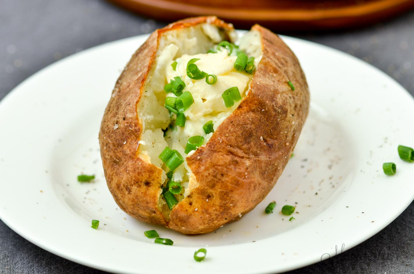 Delicious baked potato with Smart Balance and chives. Made in an air fryer.
