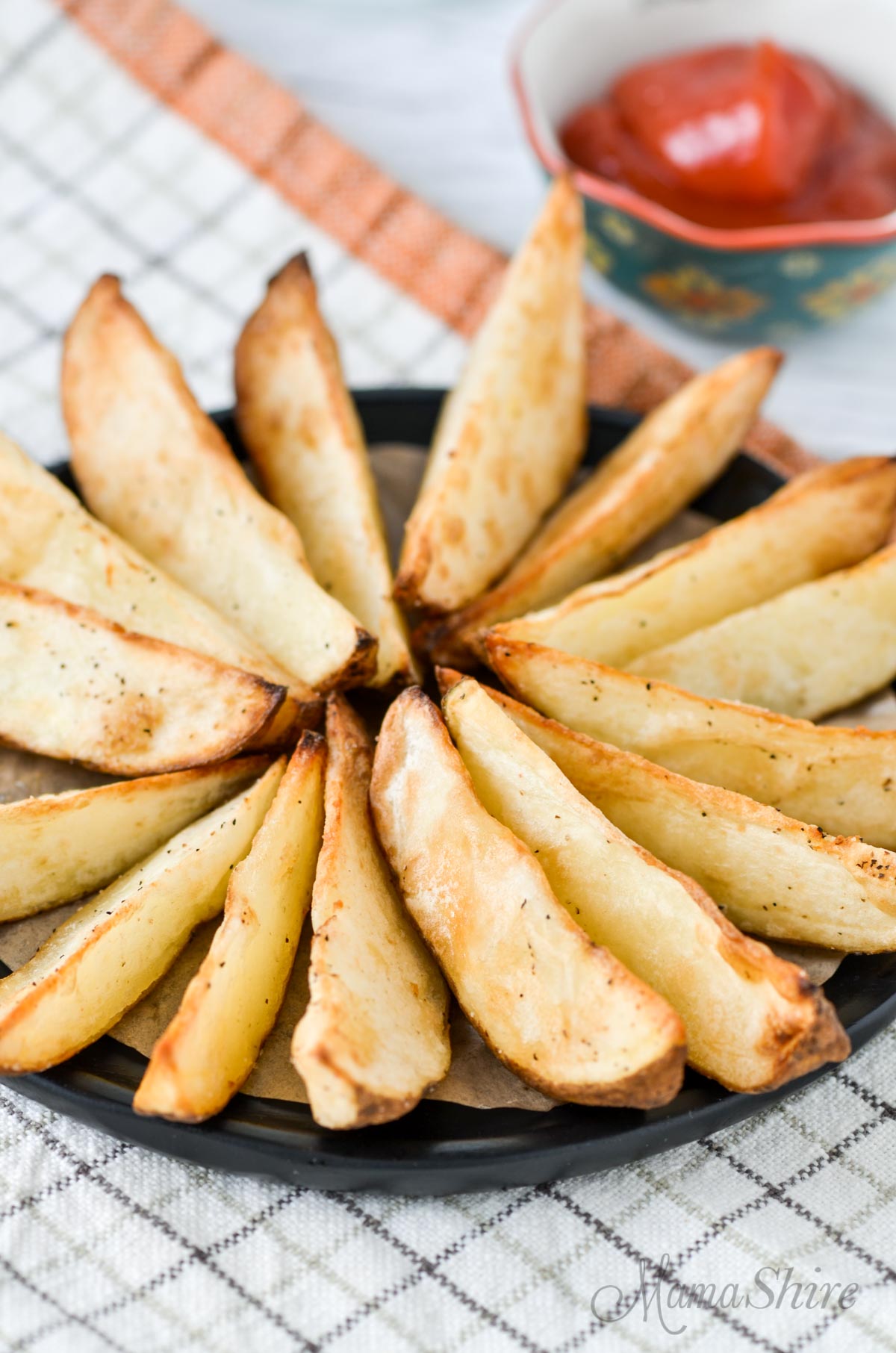 A plate of potato wedges made in an air fryer.