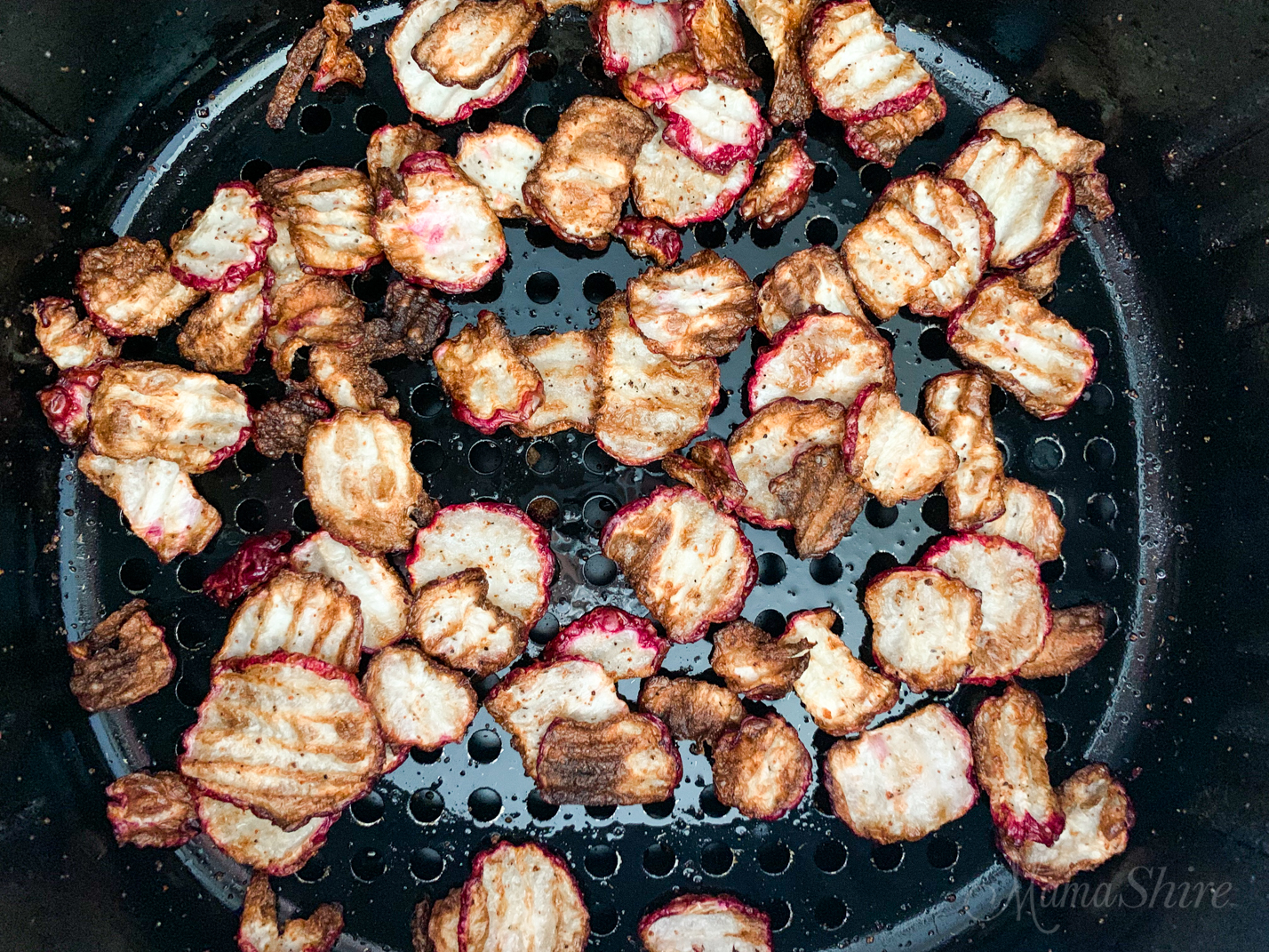 Air Fryer Radish Chips in the basket of the air fryer.