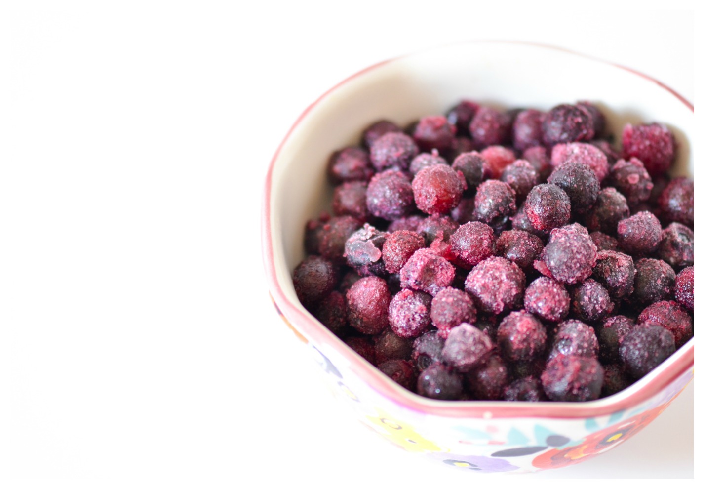 A cute little bowl of frozen blueberries
