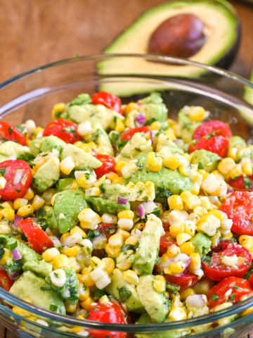 Avocado Corn Salad that includes tomatoes, red onion, and jalapeno.