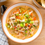 A serving of dairy-free Buffalo chicken soup in a white soup bowl.