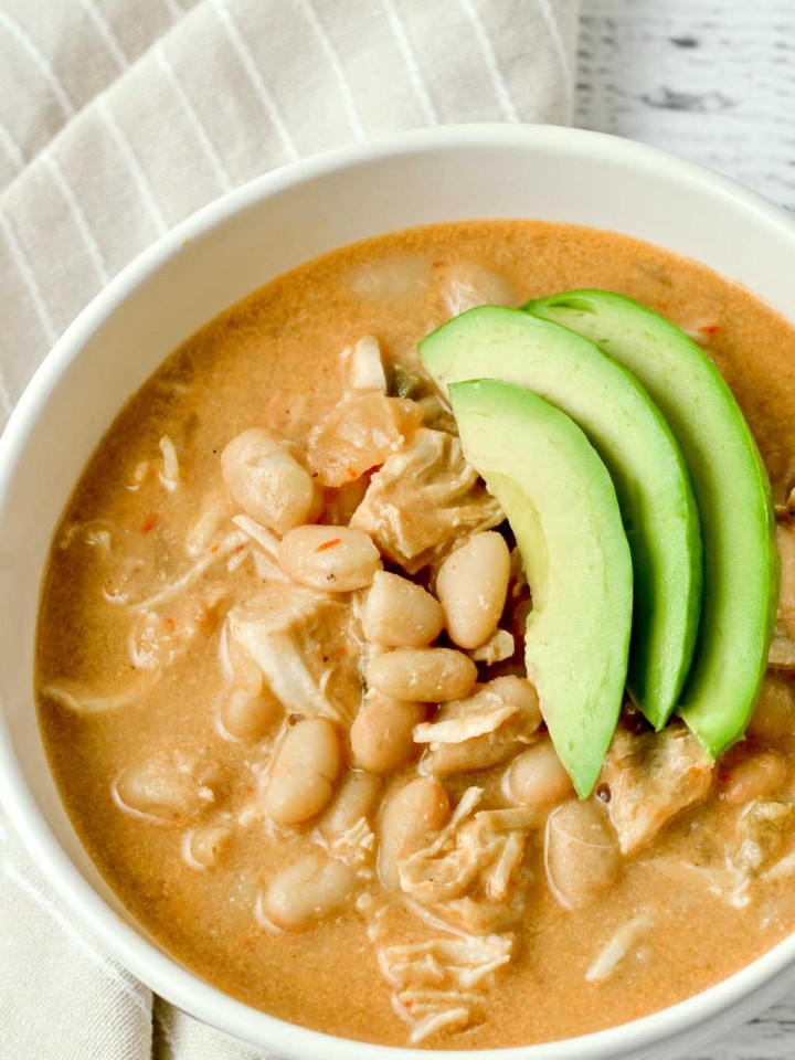 A white soup bowl with white bean chicken chili.