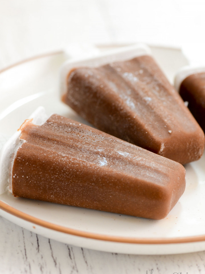 A plate with homemade dairy-free fudgesicles on it.