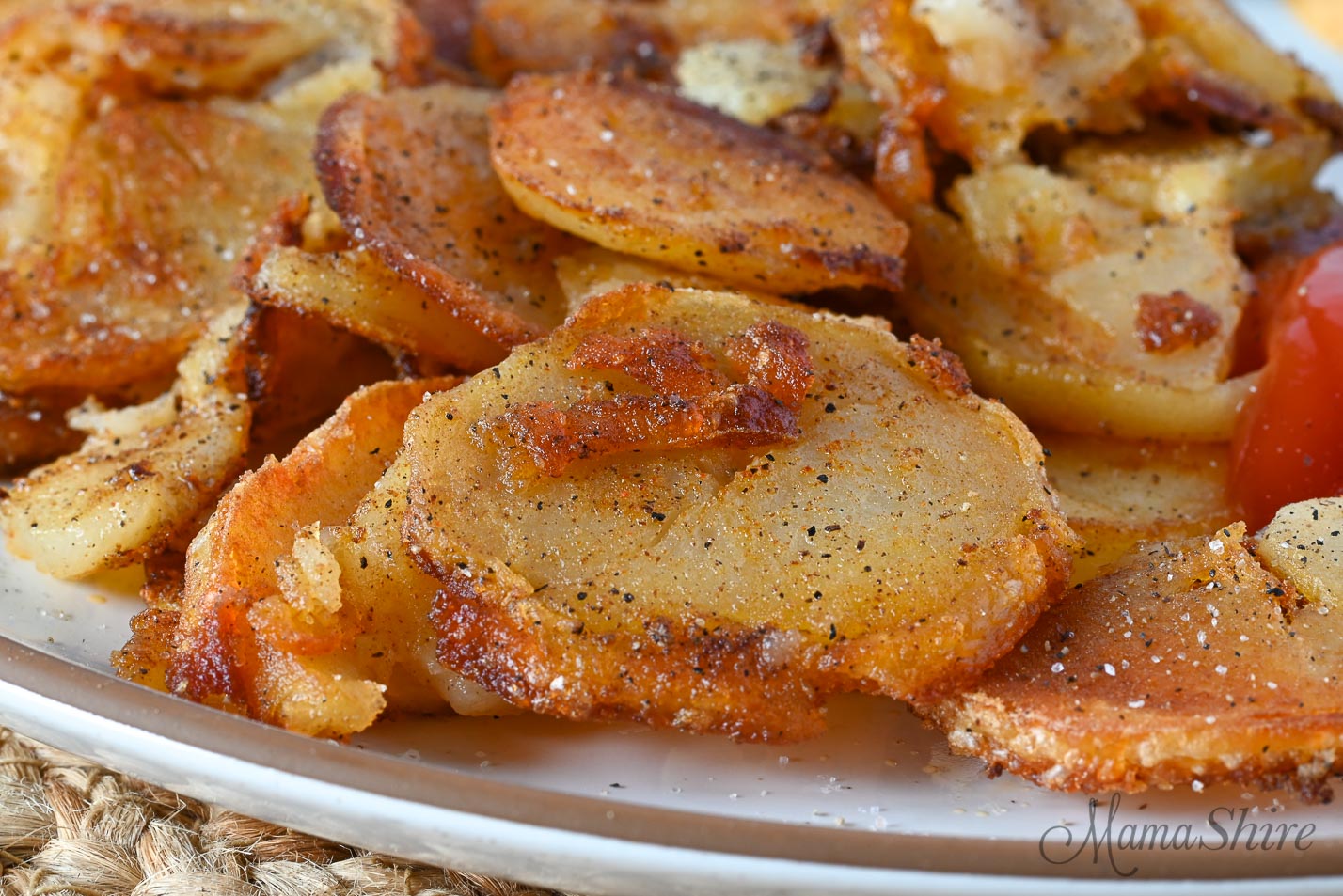 A closeup of fried potatoes that had previously cooked and chilled.