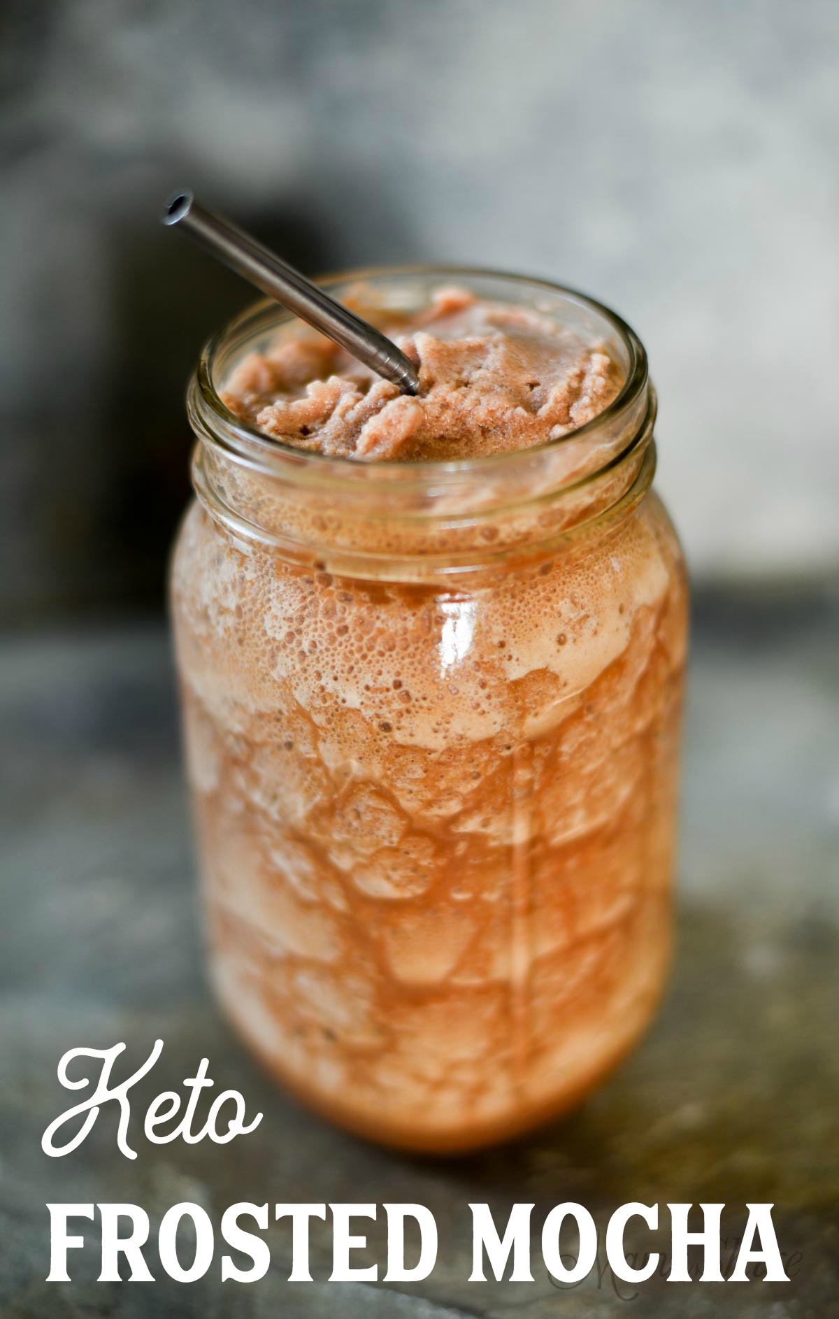 Delicious Frosted Mocha in ball jar with metal straw.