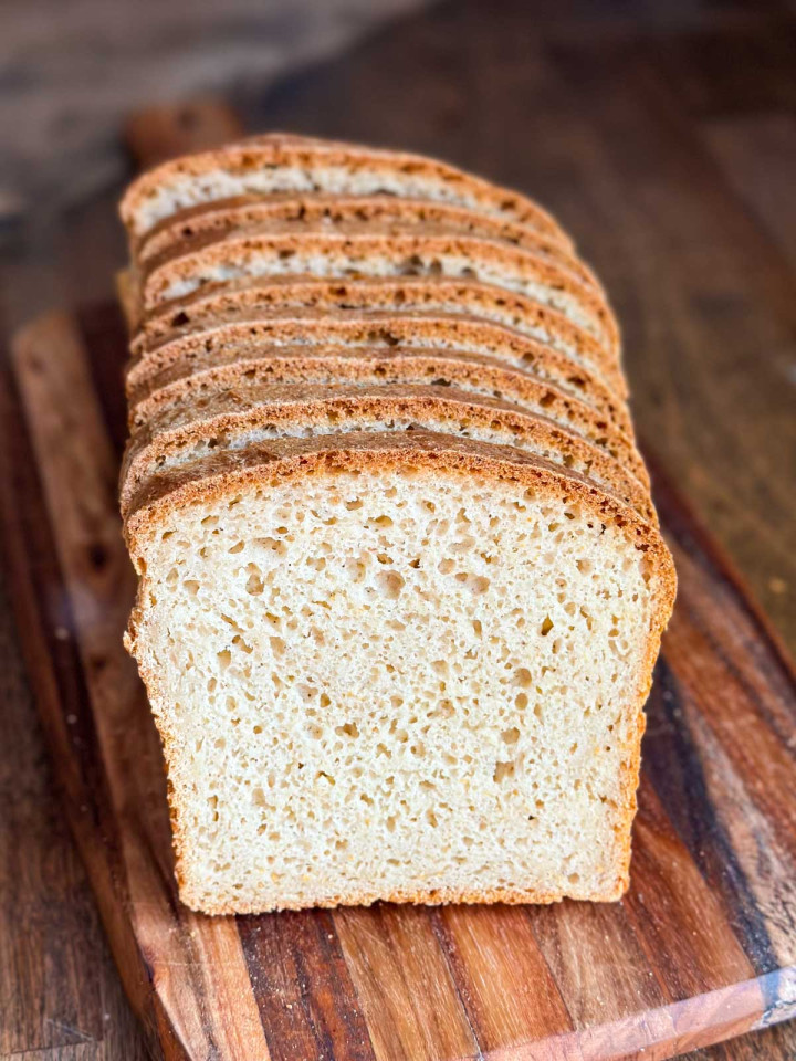 A homemade loaf of gluten-free bread that has been sliced.