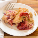 Cherry and pineapple under a cake topping.