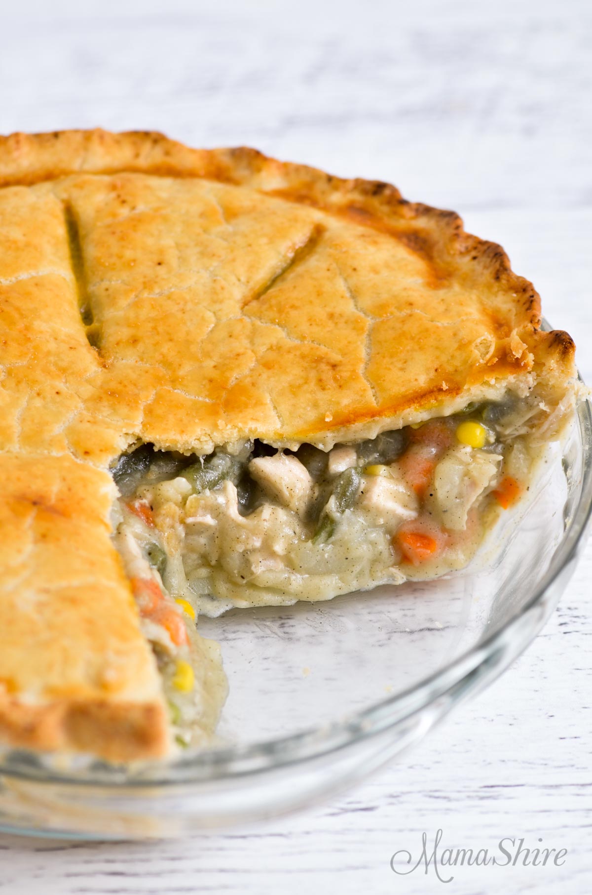 A chicken pot pie with a couple of slices removed.