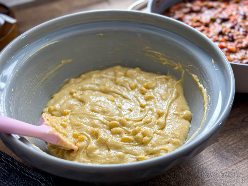 A mixing bowl with gluten-free cornbread batter.