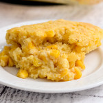 A serving of corn casserole on a little white plate.
