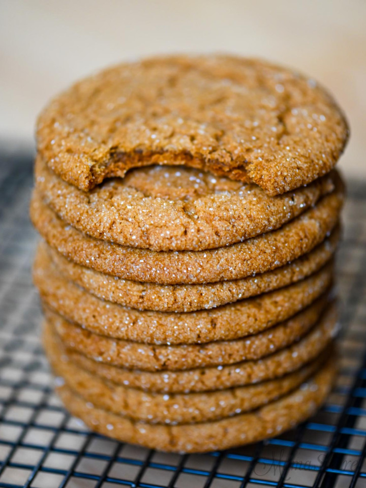 A stack of gluten-free ginger snaps with a bite out of the top one.