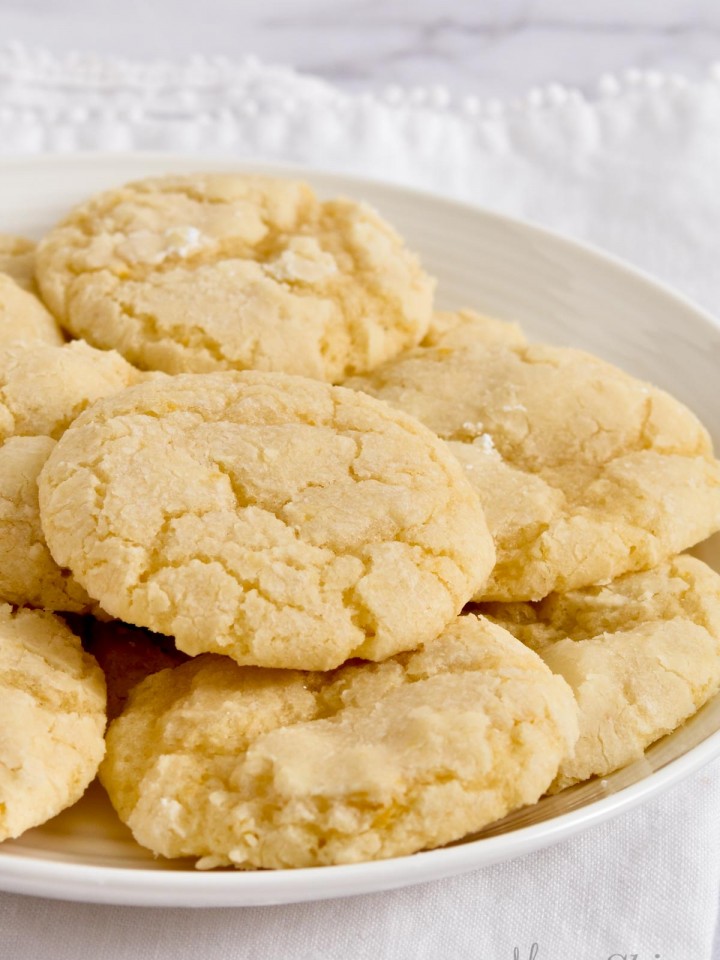 A white serving plate filled with gluten-free lemon cookies.