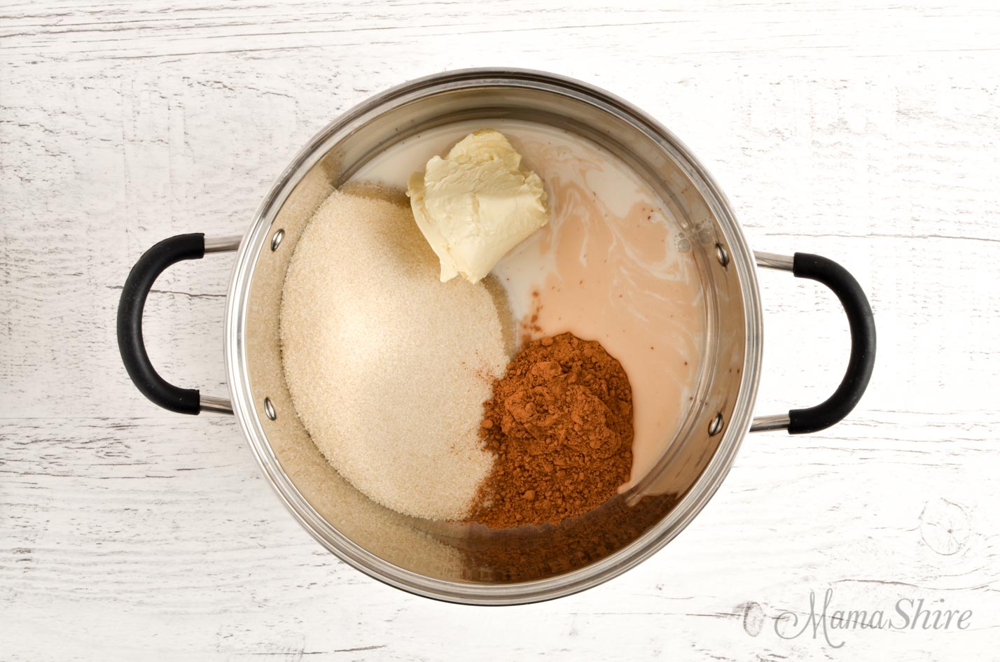 A pot with sugar, cocoa powder, Smart balance buttery spread, and almond milk. 