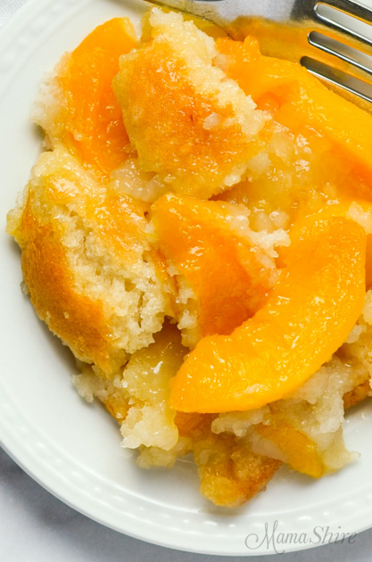 A serving of gluten-free peach cobbler on a white plate.