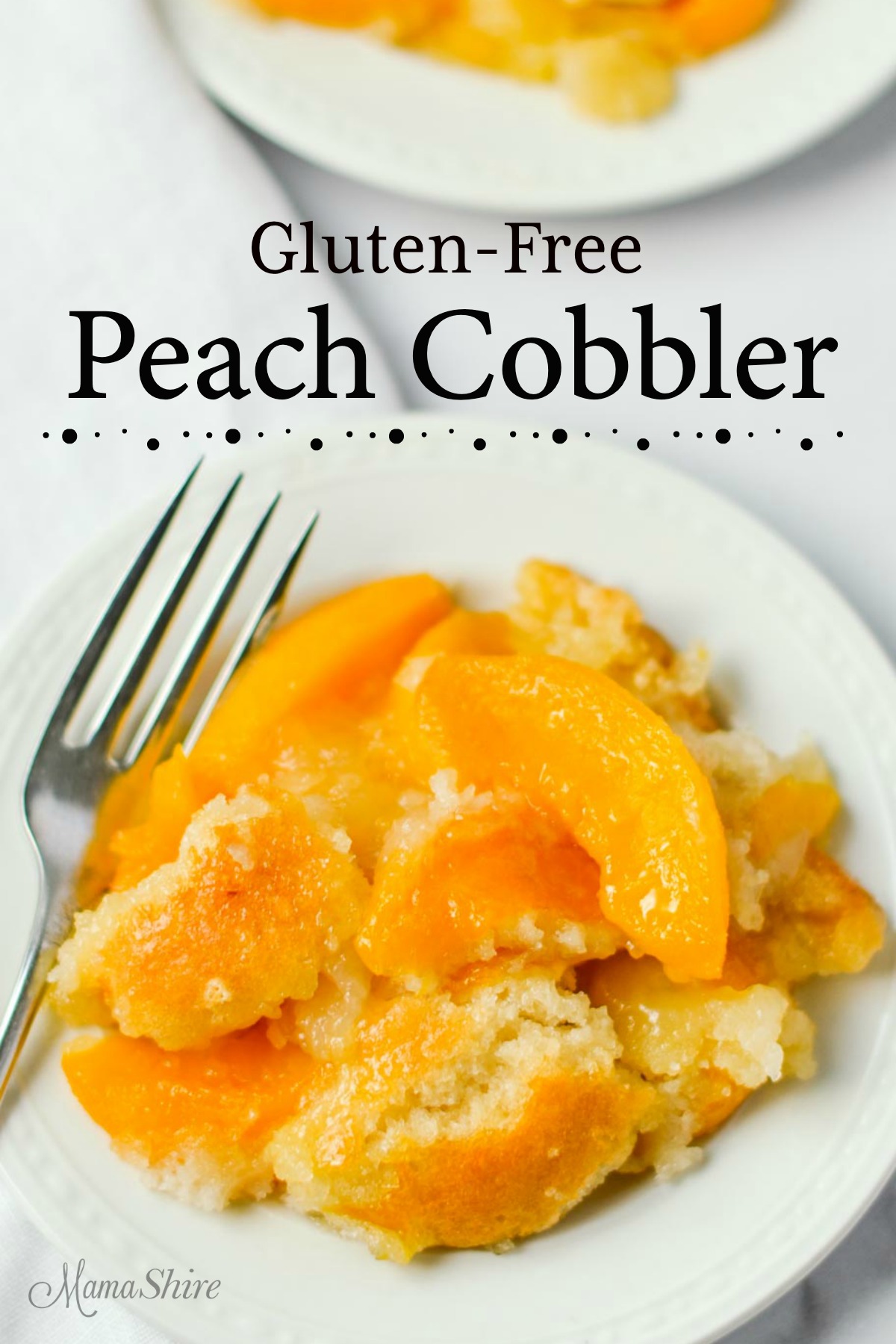 A beautiful gluten-free peach cobbler on a small white serving plate. 