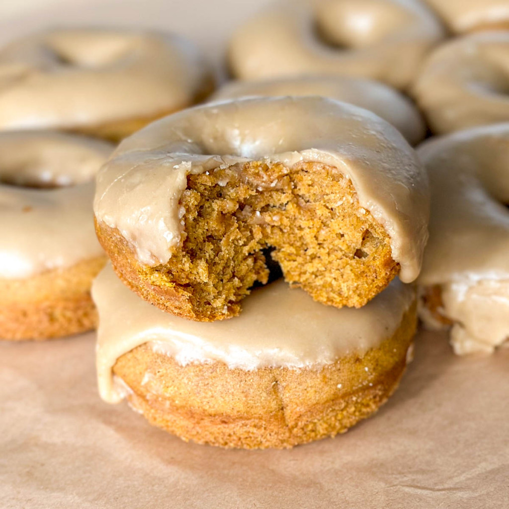 Baked gluten-free pumpkin donuts with brown sugar icing.
