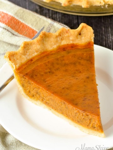 A slice of gluten-free pumpkin pie on a white plate.