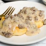 Easy to make sausage gravy over two gluten-free biscuits.