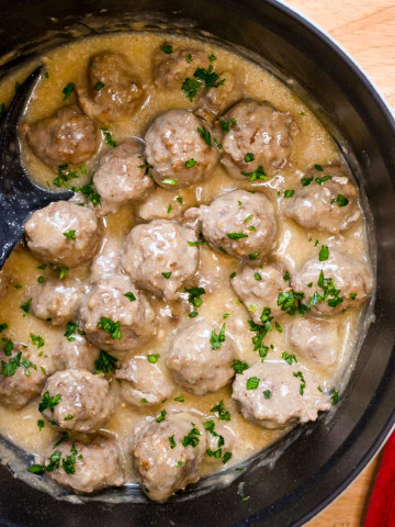 Gluten-Free Swedish Meatballs in a large Dutch oven with dairy-free gravy.