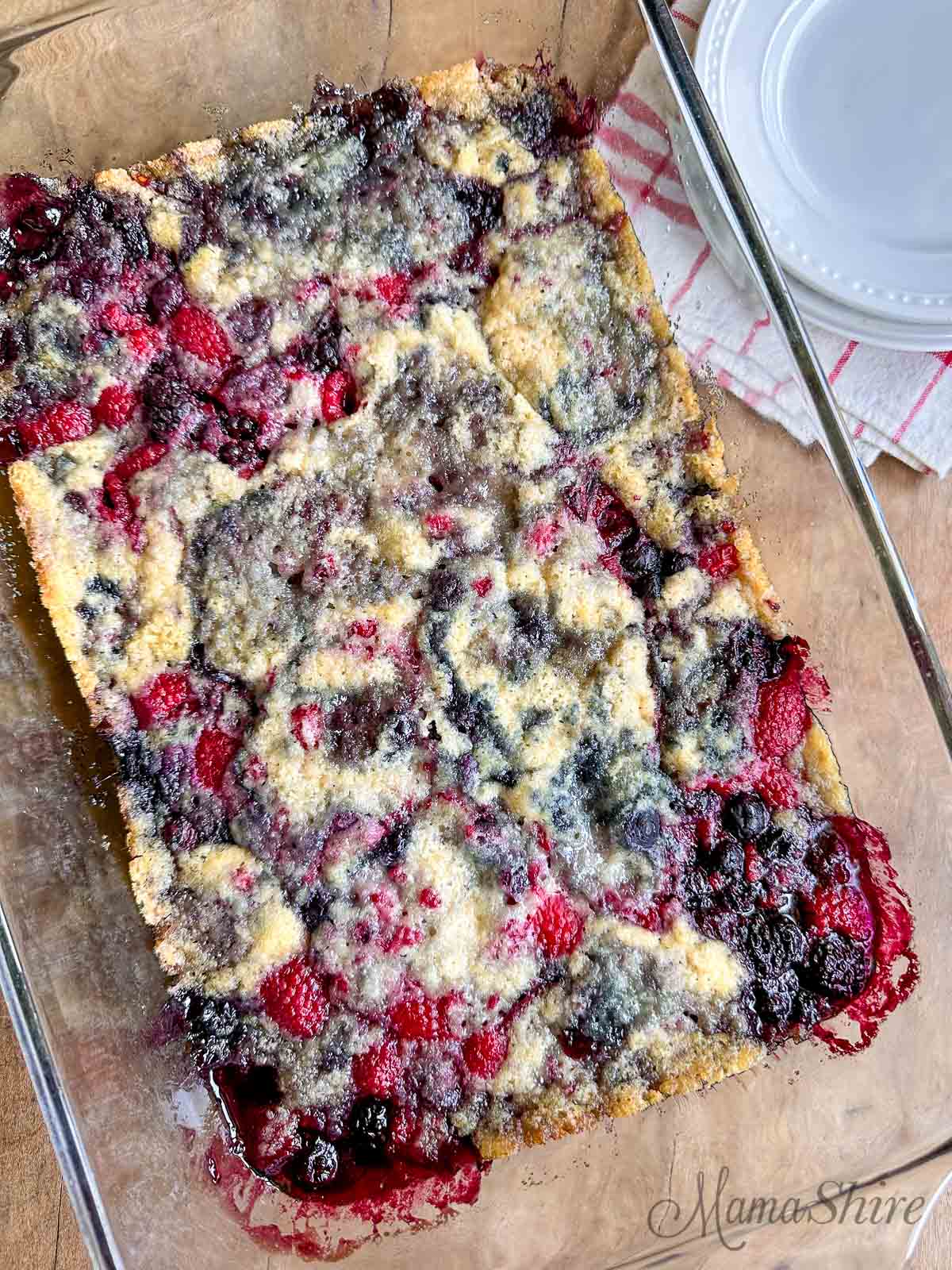 Gluten-Free Triple Berry Cobbler baked in a glass casserole baking pan.