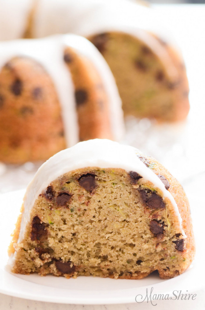 A slice of gluten-free zucchini cake with chocolate chips that was made in a bundt pan.