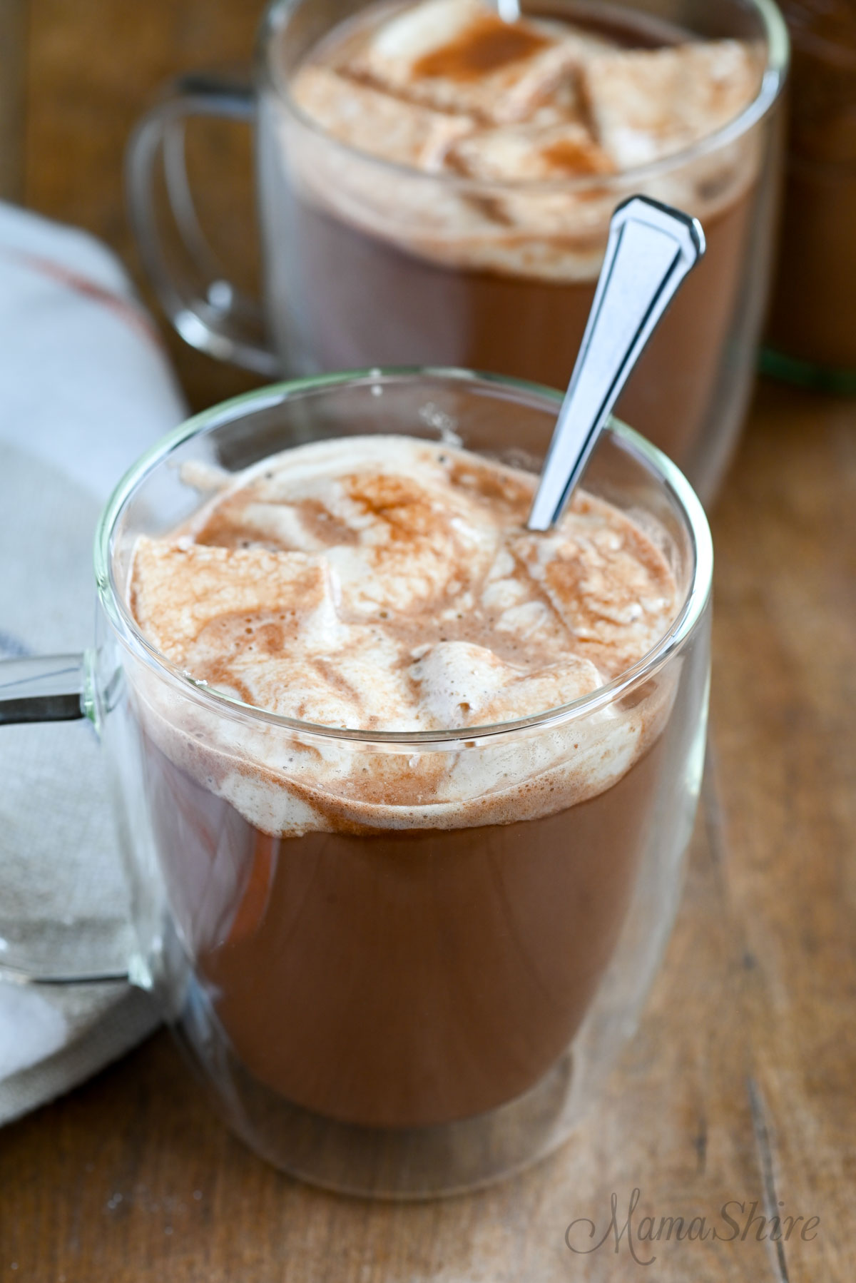 Two mugs filled with dairy-free hot chocolate and topped with homemade marshmallows.