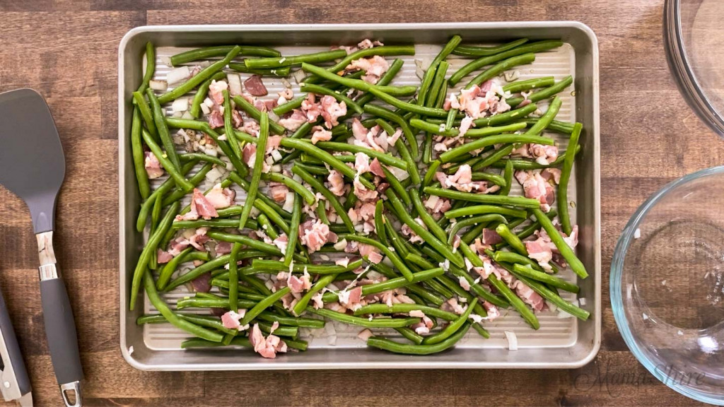 Easy roasted green beans mixed with bacon, onion, seasoned salt, pepper, and olive oil.