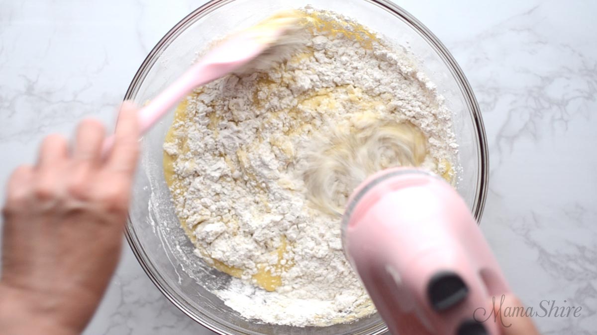 Mixing the gluten-free flour mix into the muffin batter.