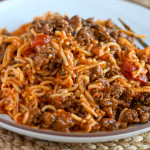 A closeup of a serving of Instant Pot Spaghetti (gluten-free) on a white serving plate.
