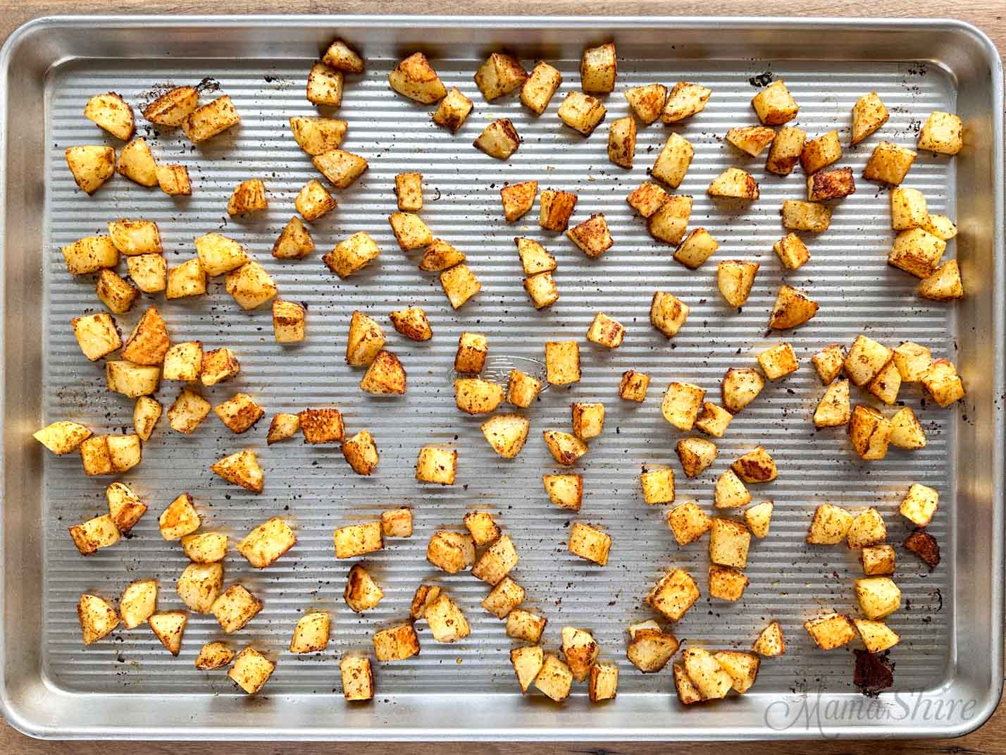 A large baking pan with roasted potatoes.