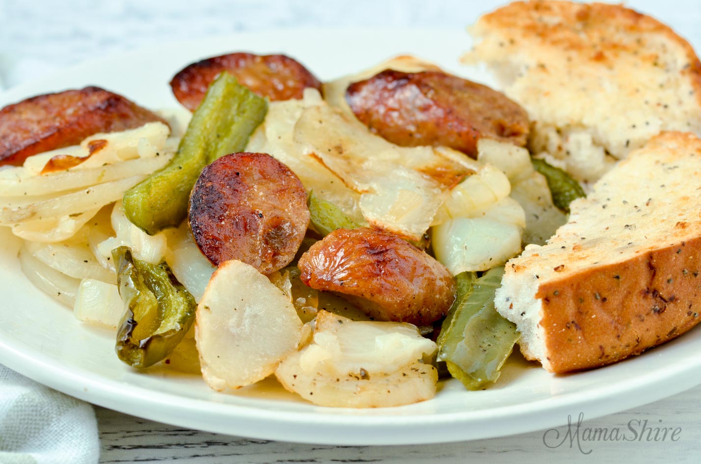 Easy roasted chicken sausage with potatoes and green pepper and a gluten-free bagel.