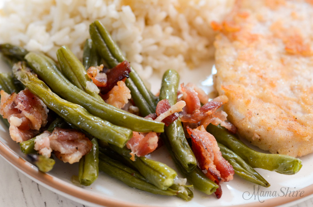 A dinner plate with roasted green beans.