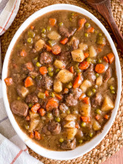 A large serving bowl with a delicious and hearty beef stew that was made in the crock pot.