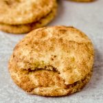 A yummy snickerdoodle cookie with a bite taken out of it.