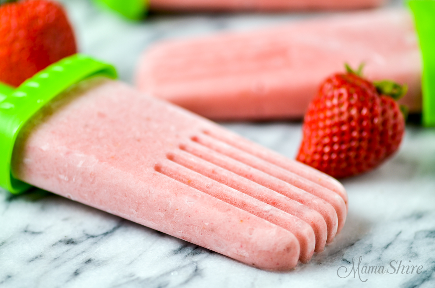 Pink popsicles made with a strawberry banana yogurt recipe that is dairy-free.