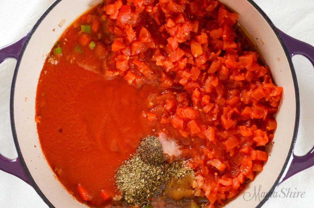 Ingredients put in a dutch oven for a stuffed bell pepper soup.